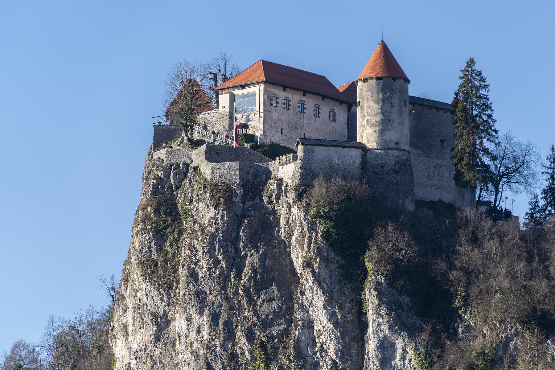Exterior view of Bled Castle standing on a cliff above Lake Bled